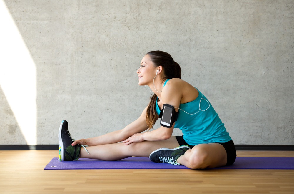 woman stretching on exercise mat